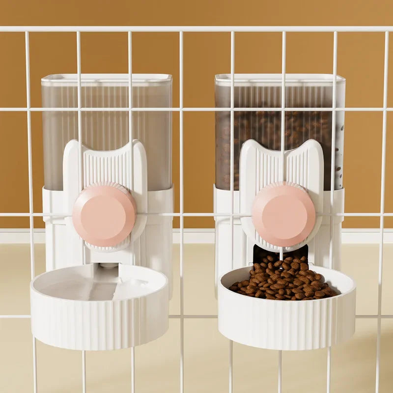  A cat hanging next to a water dispenser, while a dog drinks from a water bowl below. In the background, there is an automatic feeding system, and a rabbit cage with a hanging water bottle. The setup shows various pet supplies for different animals.