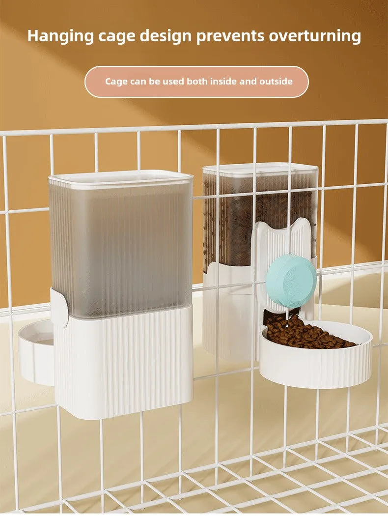  A cat hanging next to a water dispenser, while a dog drinks from a water bowl below. In the background, there is an automatic feeding system, and a rabbit cage with a hanging water bottle. The setup shows various pet supplies for different animals.